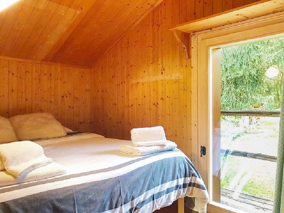 Comfortable bedroom with a window that lights up the room.