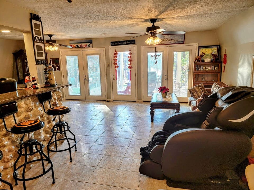 5 doors living room w/ top of the line  massage chair on tile flooring