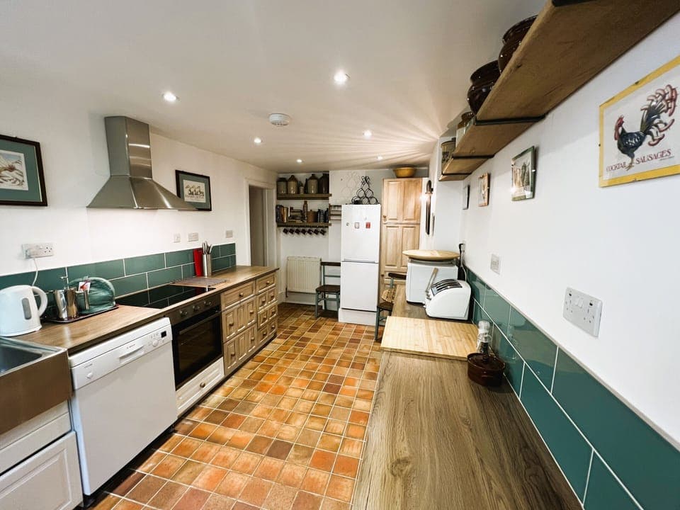 Enjoy cooking and dining in the charming country kitchen at 2 Apse Castle Cottage, the perfect space for a relaxing holiday near Shanklin on the Isle of Wight