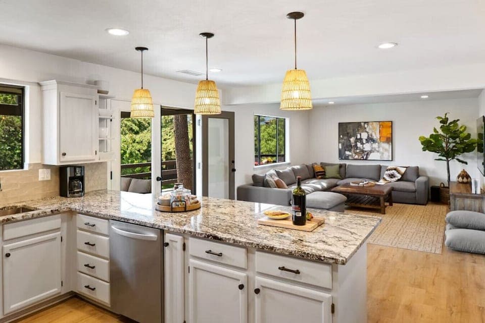 The kitchen overlooks the living room and its 75-inch smart TV