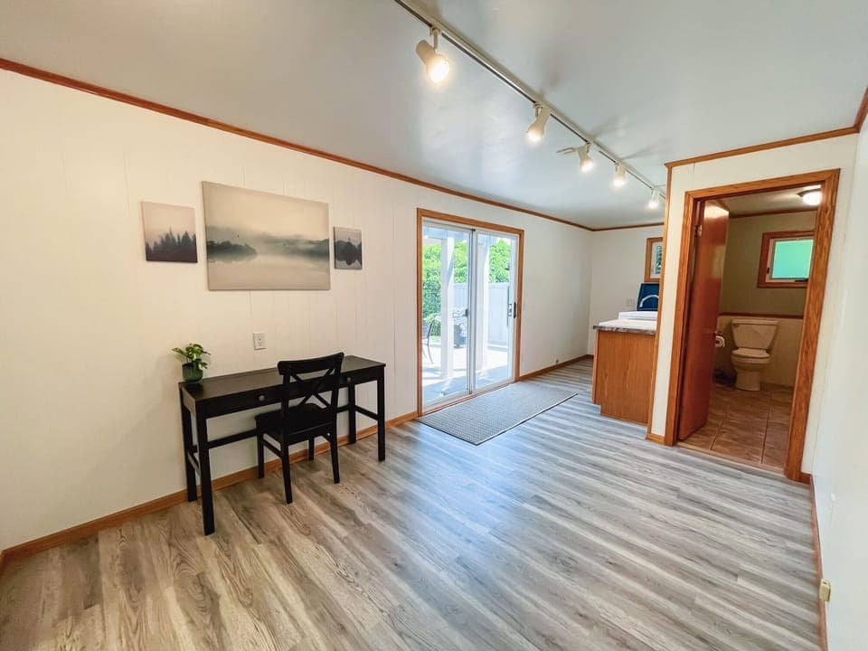 Desk, patio door, laundry, bathroom door. (L. to R.)