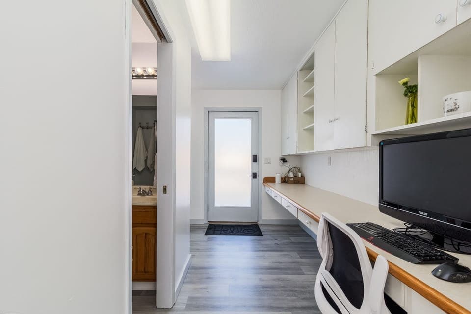 Work station that includes an ergonomic chair, 27" monitor, keyboard and mouse.