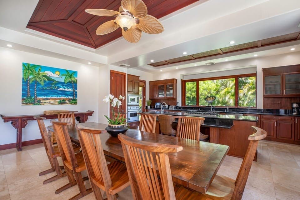 Warm wood dining room with seating for eight and tropical-inspired décor.