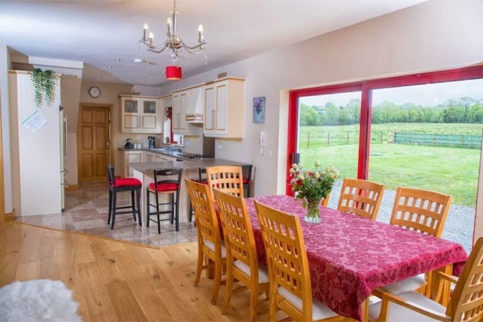 Dining area with stove and entrance onto patio