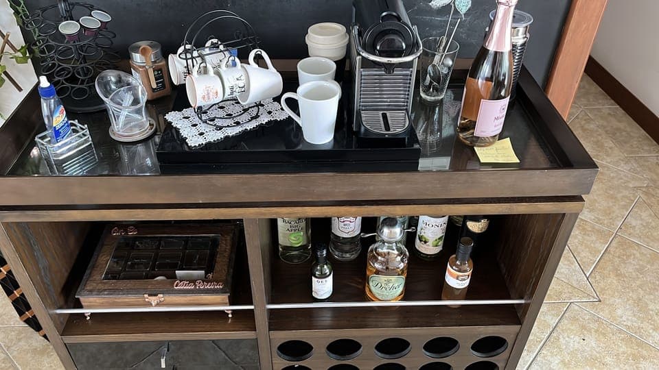 Deluxe House | Living area | 42-inch flat-screen TV with satellite channels, TV, books