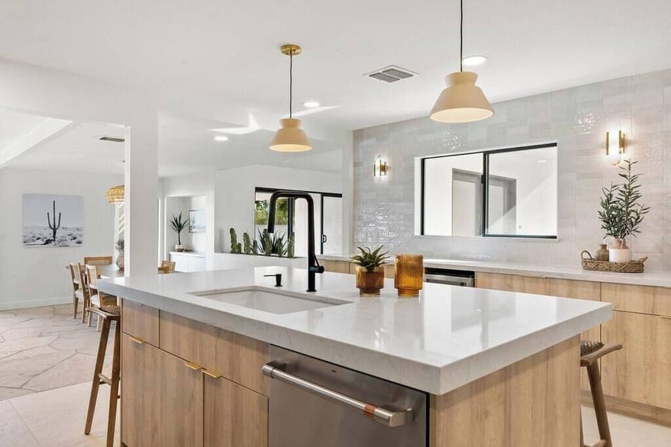 Modern kitchen with a large island and natural wood cabinetry