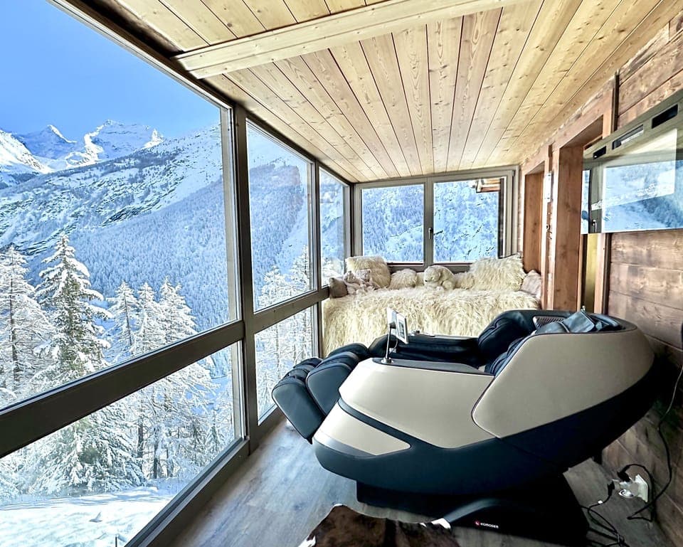 Wellness room with massage chair and sauna.