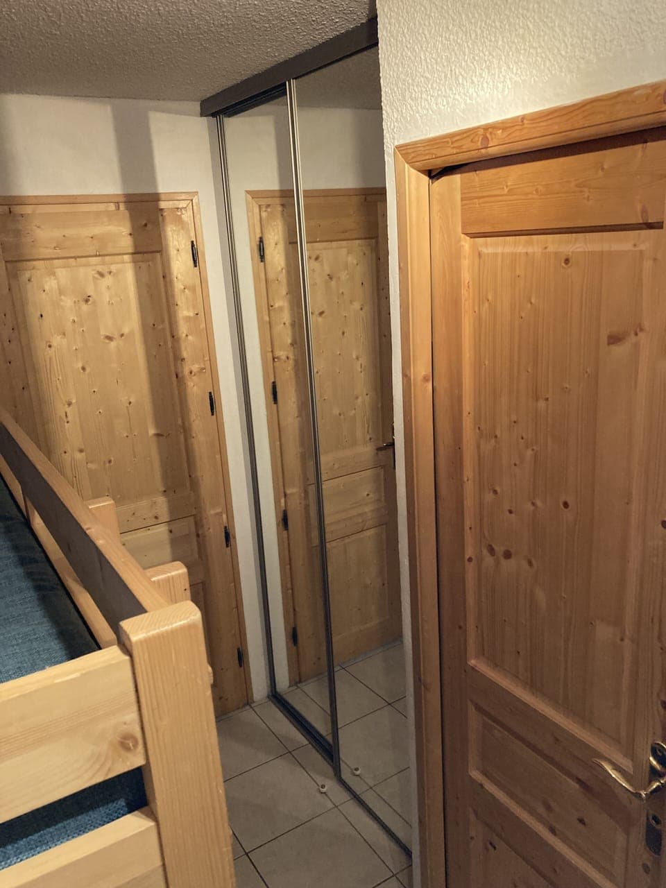 Doors to living room and bathroom. Mirror wardrobes