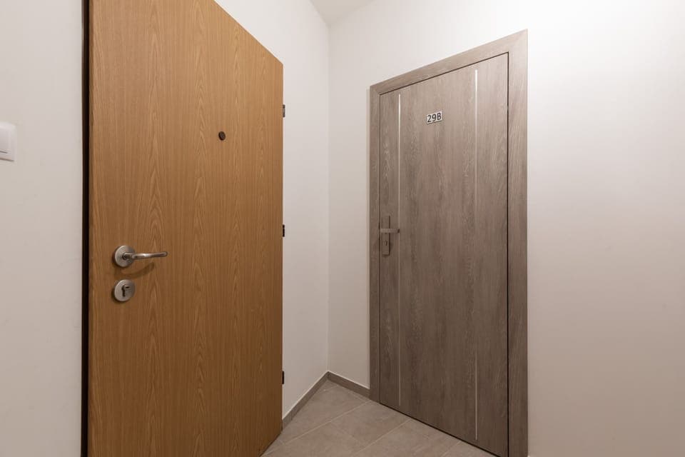 Another perspective of the entrance area, highlighting a different door style.

