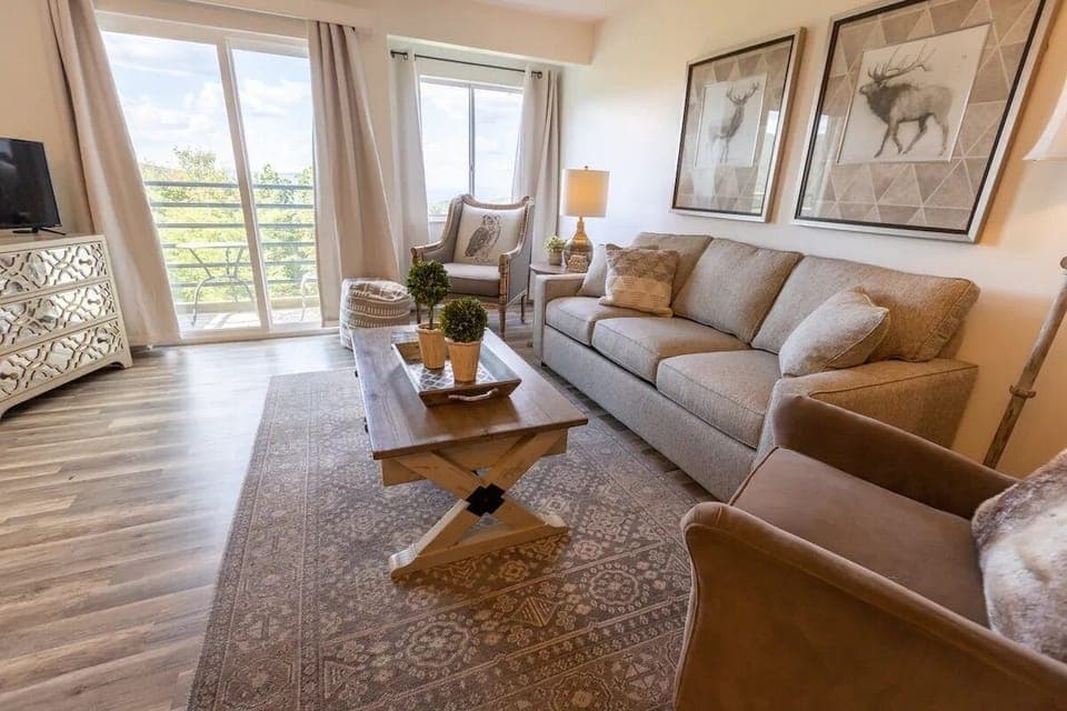 Relax watching TV in the living room that opens onto the private patio. 