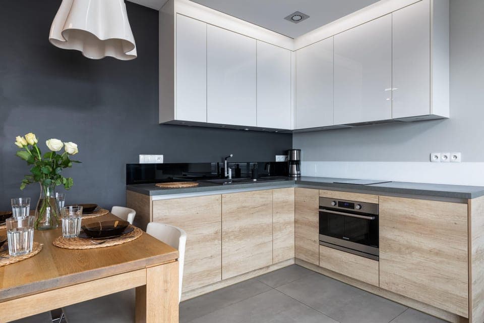 A modern kitchen with sleek wooden cabinets, offering a spacious and functional cooking space with integrated appliances.