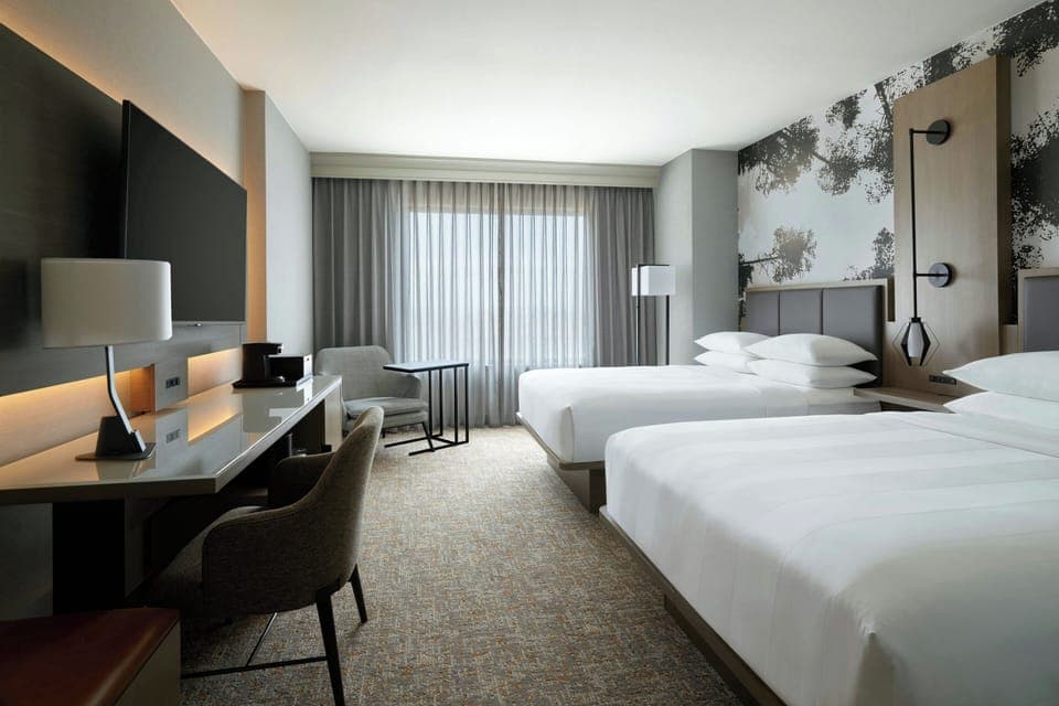 Premium bedding, desk, laptop workspace, blackout drapes