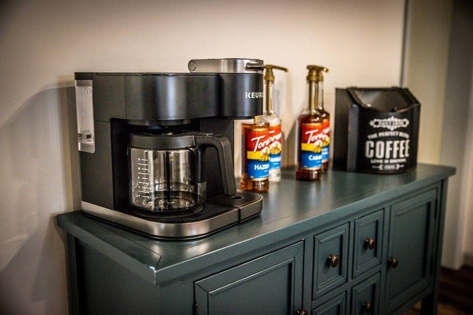 The coffee/tea bar is stocked with hot tea, hot chocolate, coffee varieties, and to-go cups.  A Keurig for both K-cups and drip coffee is available along with complementary Torani syrups and creamers for that perfect morning cup of coffee.
