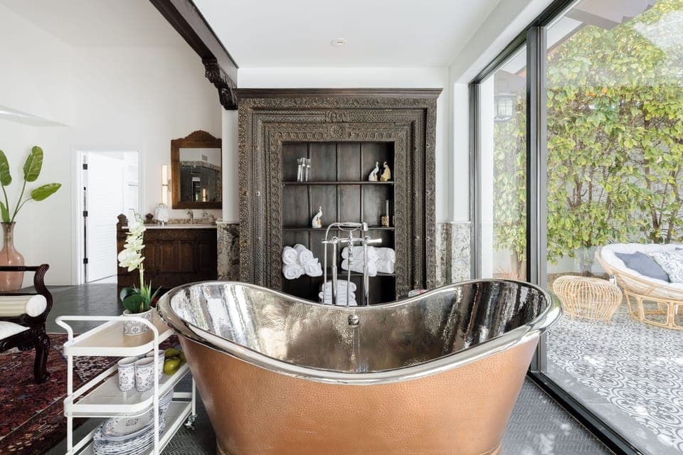 Bedroom 1: Primary Bathroom w/ Water Closet, Shower, Two Vanities, Soaker Tub, and Private Courtyard