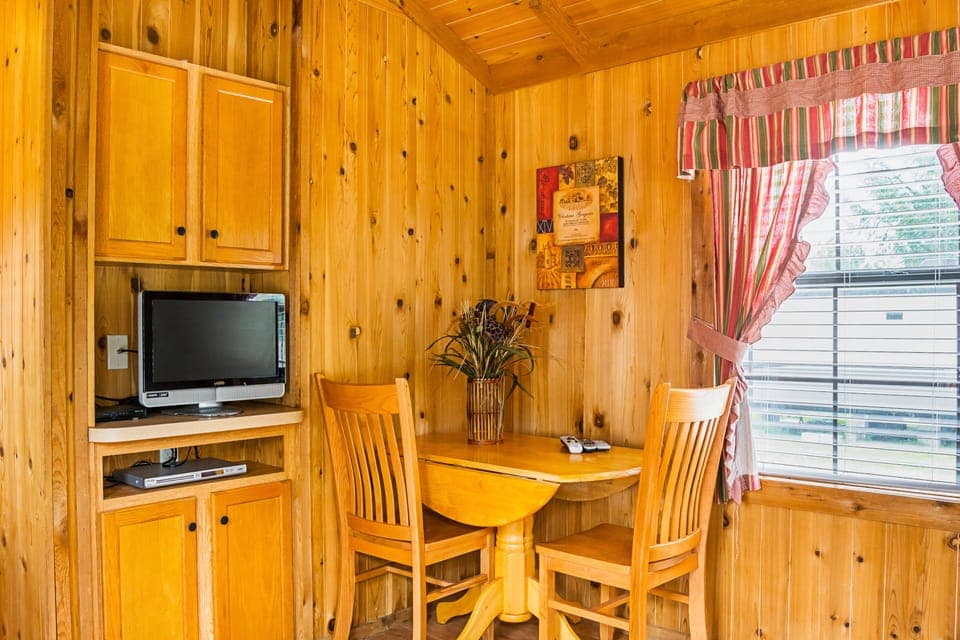 Premium Cabin, 1 Bedroom ( Linens Incld) | Living room | 25-inch flat-screen TV with satellite channels, TV, DVD player