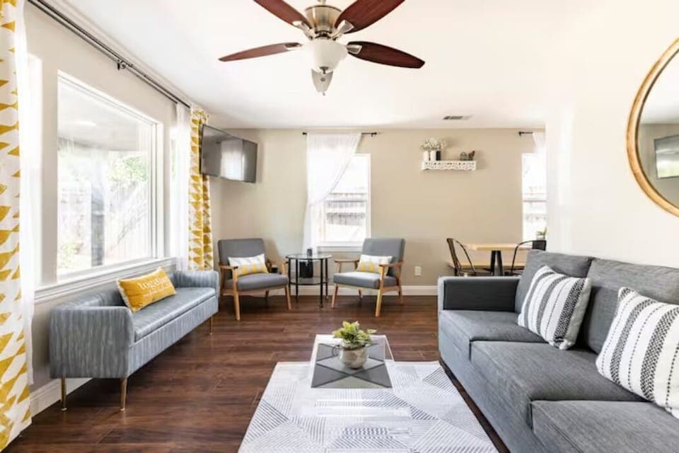 A comfy living room with plenty of seating, right off the dining area & kitchen.