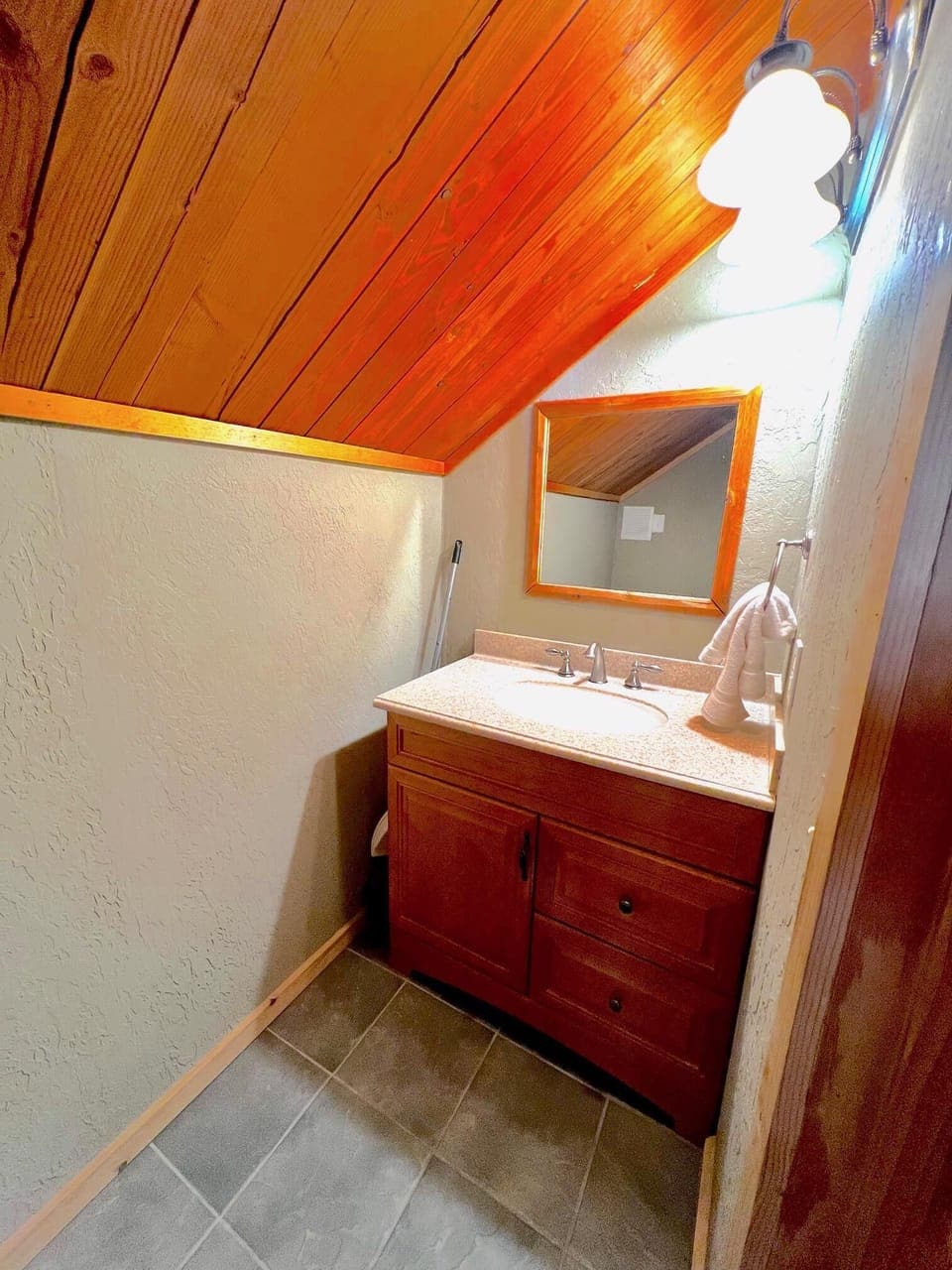 Spacious bathroom with ample storage and warm wooden finishes.