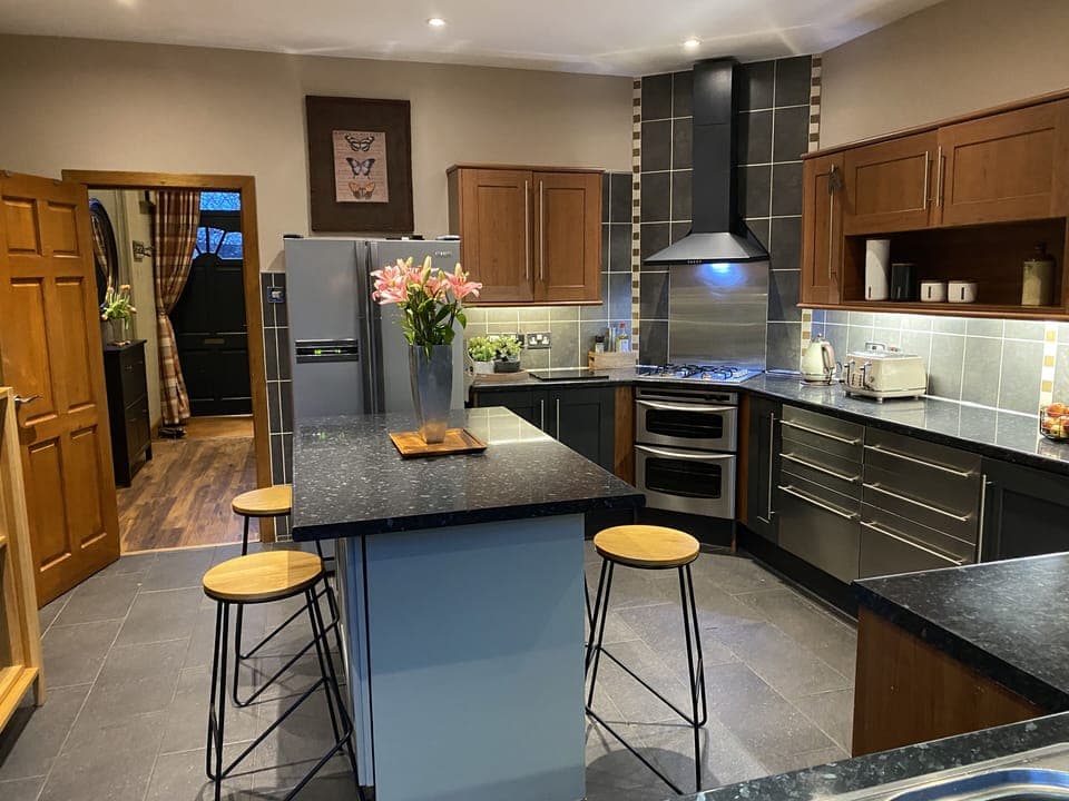 Fully fitted kitchen leading onto outside patio/dining area. 