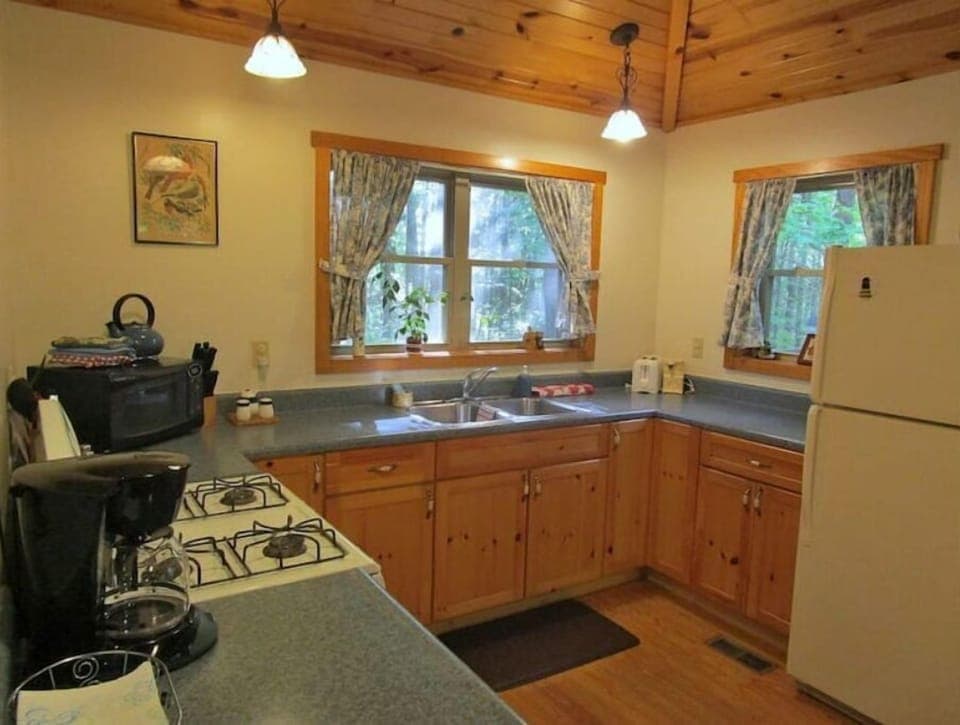 A large kitchen with plenty of light; full sized appliances, lots of work space