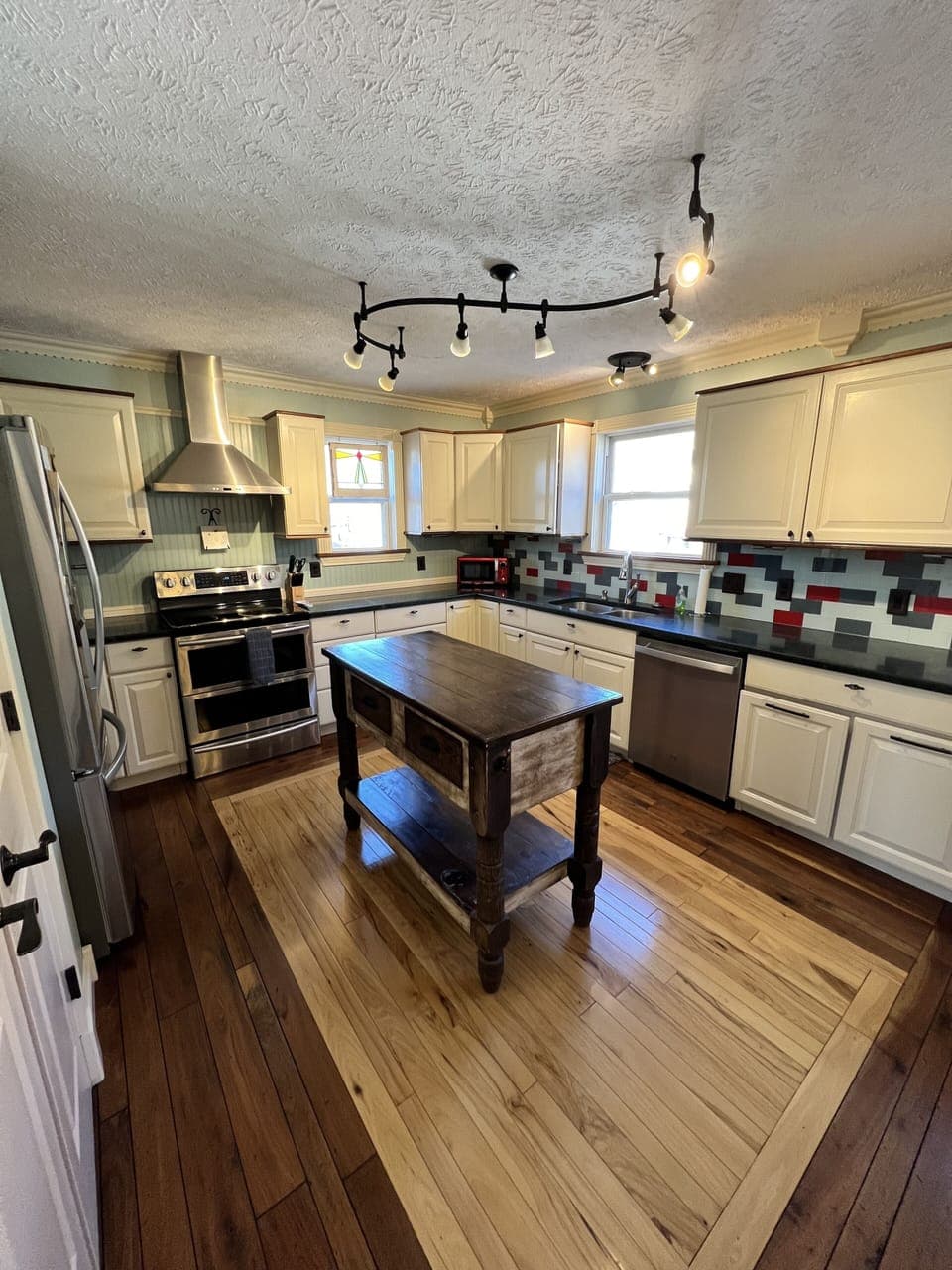 Fully stocked kitchen with electric stove/oven, dishwasher and fridge