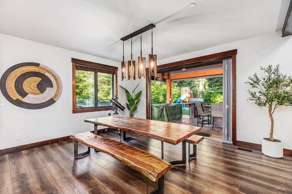 Live-Edge Dining Table With Designer Lighting And Seamless Outdoor Flow