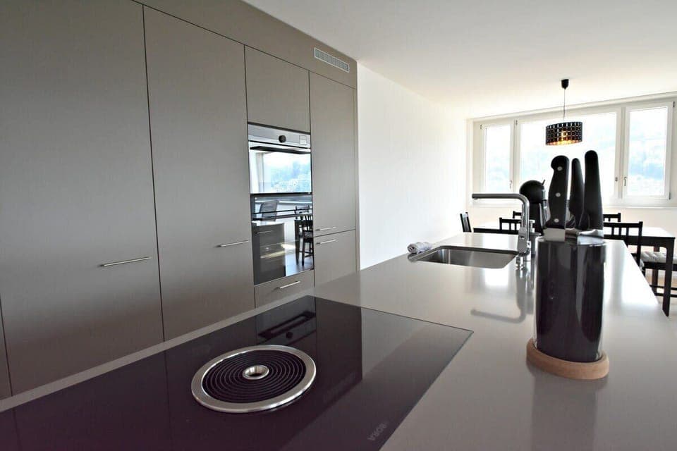 Kitchen island with stovetop and integrated oven.

