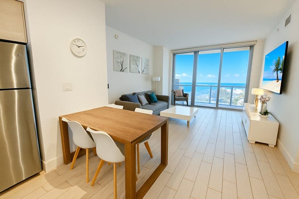 Modern dining area connected to a fully equipped kitchen.