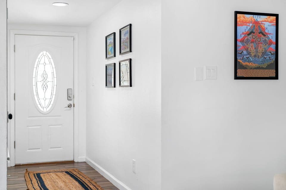 Step into our inviting entryway adorned with beautiful picture frames, setting the tone for a warm and welcoming atmosphere.