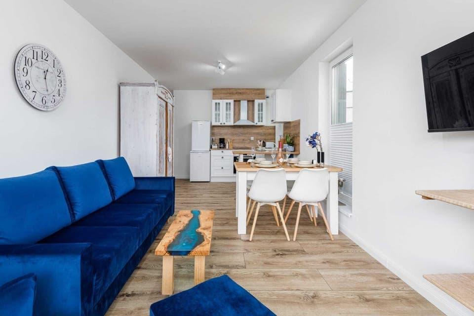 The living area features a coffee table and a flat-screen television.