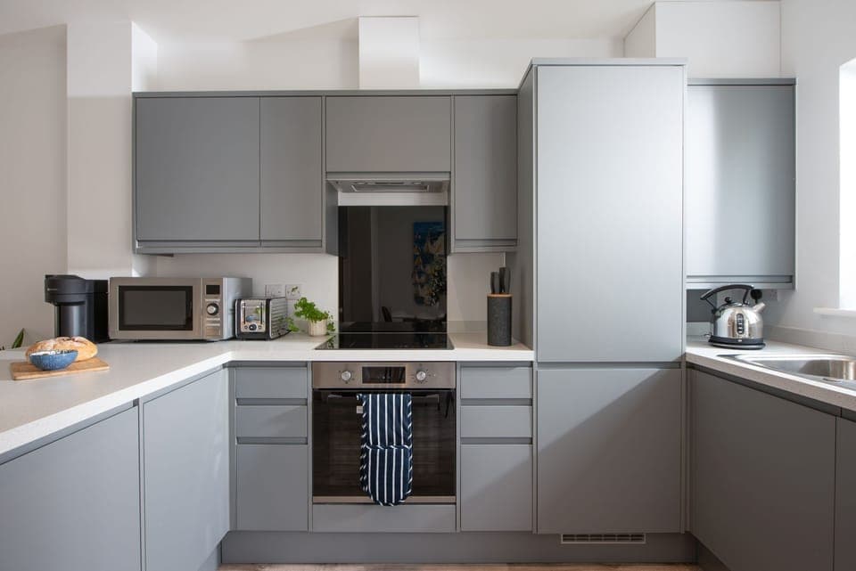 Kitchen fitted with electric oven, induction hob, microwave, toaster, kettle, fridge/freezer, dishwasher, washing machine and Nespresso pod machine - Towans Retreat