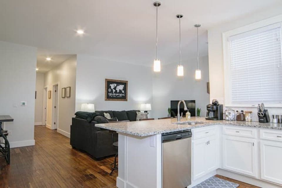 Open concept kitchen, dining, and living space in unit #5