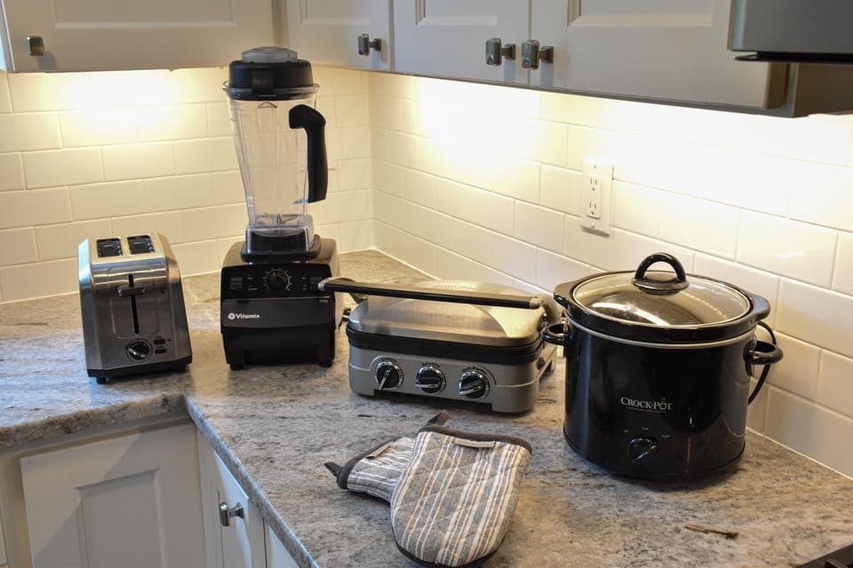 Toaster, blender, grill, crockpot plus plenty of pots and pans