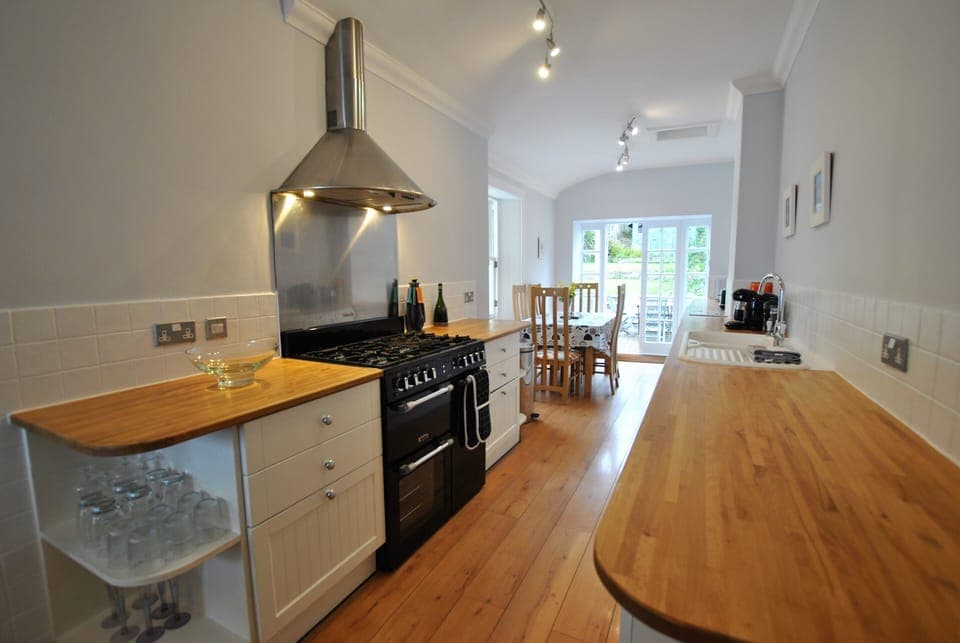 The well-equipped kitchen has plenty of space for cooking and preparing meals