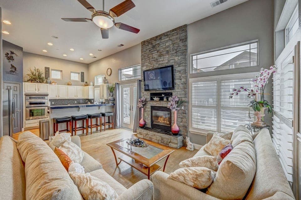 Family room with gas fireplace and large TV.