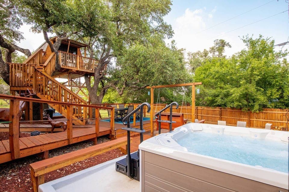 Embrace the enchanting ambiance of an outdoor oasis, complete with a bubbling hot tub and a charming fire pit seating area, ideal for cozy gatherings.