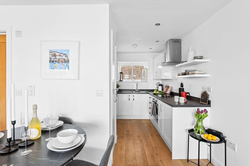 Dining table with seating for all guests, leading onto the kitchen - Osprey 3, The Cove