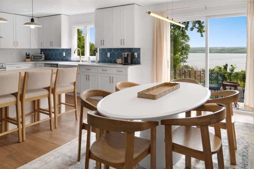 Unit 6466 (1 of 3) Dining area with panoramic lake views, ideal for family meals or entertaining guests. The sleek design and natural light create an inviting atmosphere. 
