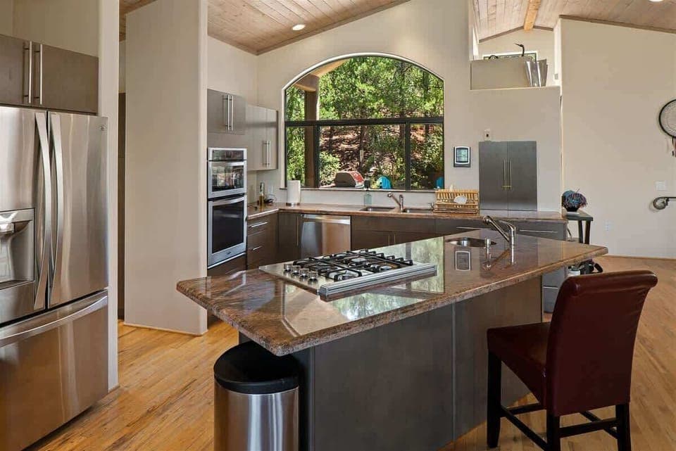 With stainless steel appliances, plentiful workspace, granite countertops and a breakfast bar
