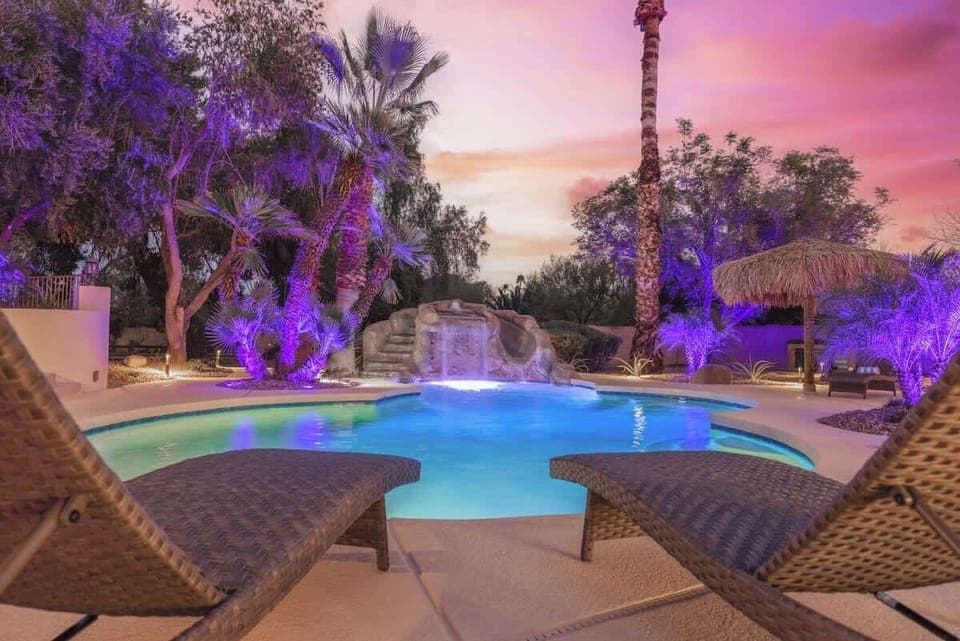 Poolside loungers offering a front-row seat to the serene backyard oasis.