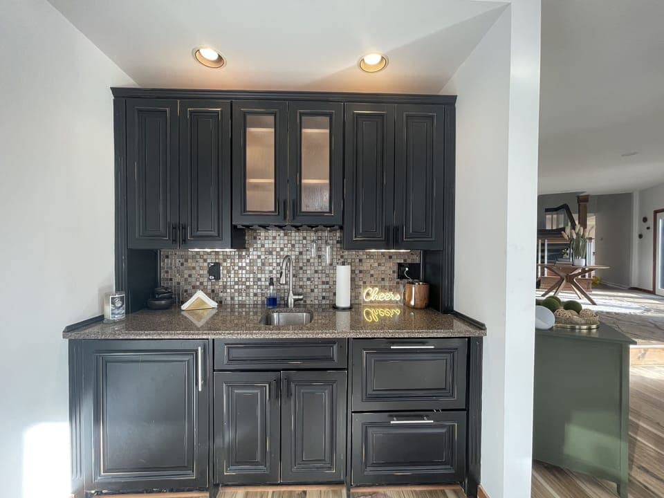 wet bar with a large wine/drink refrigerator and two drawer refrigerators. 