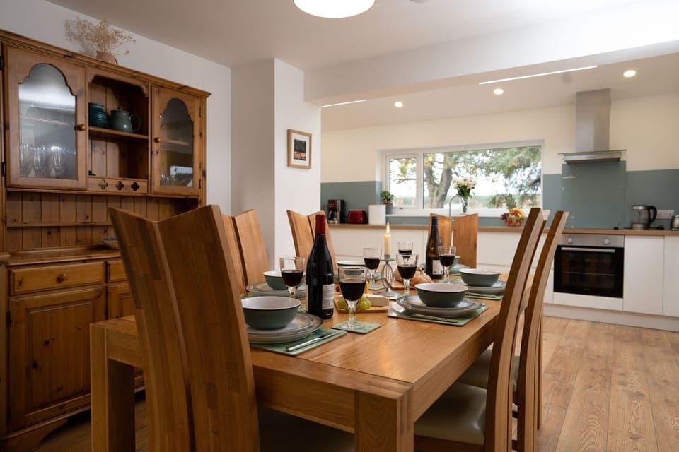 Rivercroft table set for dinner with kitchen behind