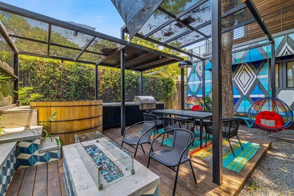 Backyard with grill, fire pit, NEW hot tub, NEW sauna, and floating swings.