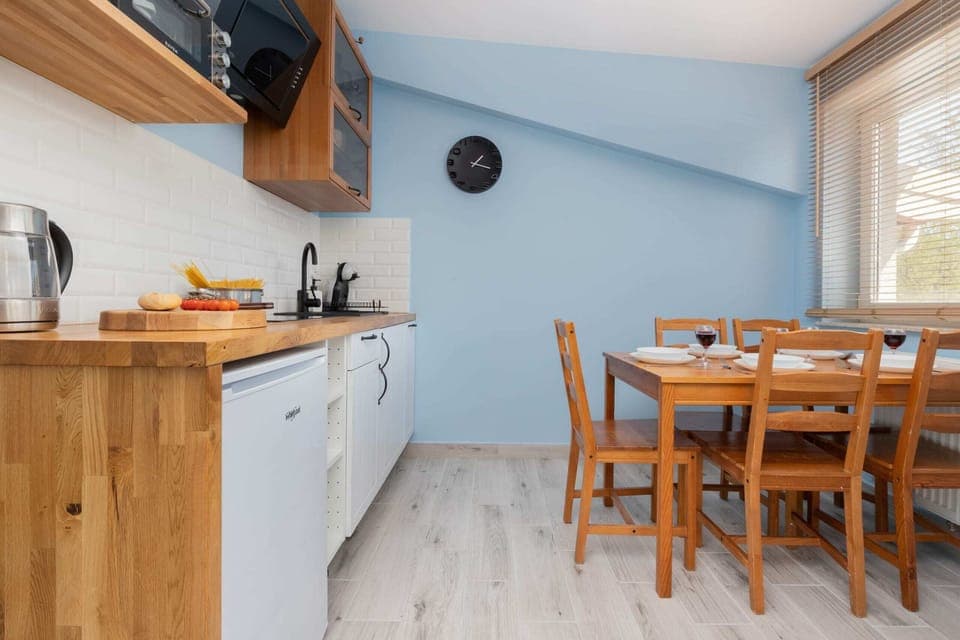 Spacious dining area with fully equipped kitchenette.