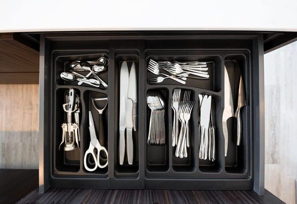 Fully stocked with sleek cutlery and utensils for your culinary needs.