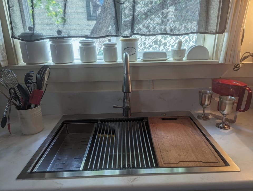 Farm style sink,  colander, roll up drain rack, chopping board, space saver.