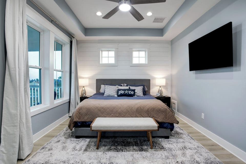 Master bedroom with HDTV, walk out private deck, tv, closet and master bathroom