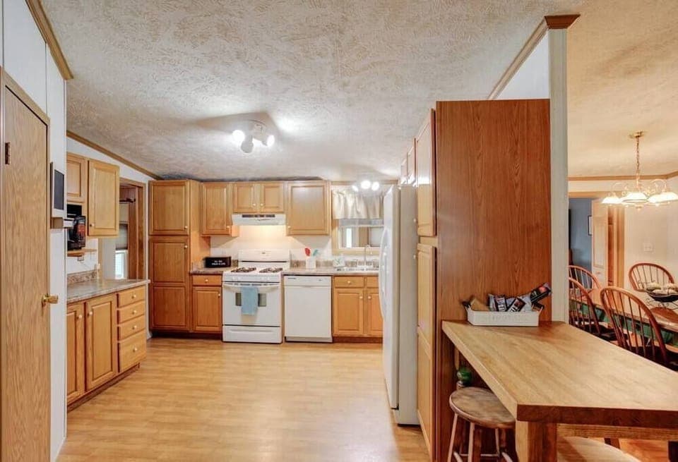 Kitchen area, bar seating connects to living room and dining room
