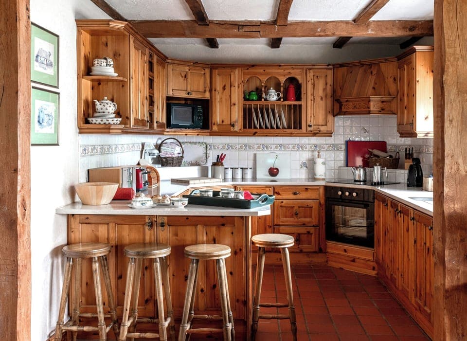 Farmhouse style pine open plan kitchen with breakfast bar and sea view.
