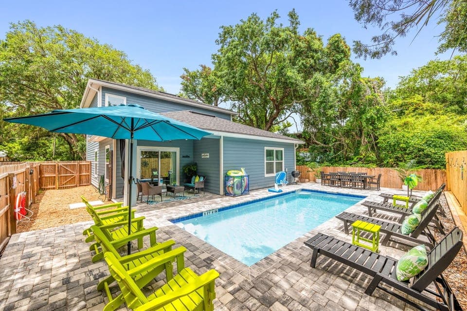Escape to your own tropical oasis: enjoy the heated saltwater pool, charcoal grill, and outdoor shower!