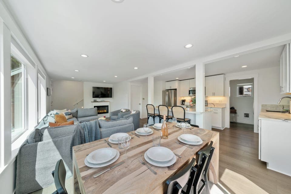 Dining room open to Living room with electric fireplace, Streaming TV, and kitchen with Bar seating.